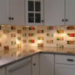 Fascinating Backsplash Designs Themed in Floral Motif Combined with White Kitchen Cabinets and Granite Countertop