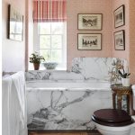 Beautiful Small Bathroom with marble Bath Tub Under the Pink Wall with Photograph