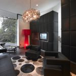 Darker color Hues from Wardrobe and Flooring with Round Motives Carpet and Branch Chandelier
