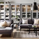 Neat and Sophisticated Reading Room with Grey Chairs in front of Large Shelving Units with Books