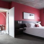 Red Walls in Bedroom INterior in Neutral Palette and Tall Floor Lamp