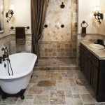 Rustic Dark Colored Bathroom with Stone Texture Flooring and White Bathtub and Dark Counter