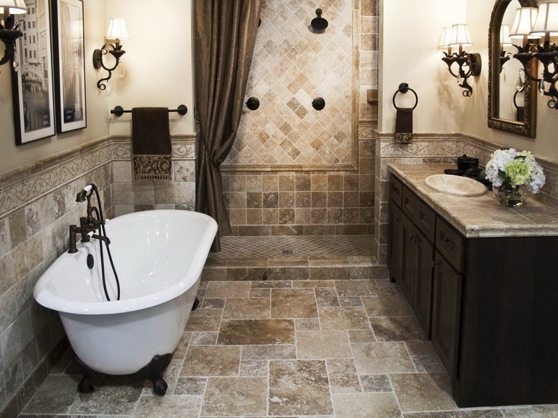 Rustic Dark Colored Bathroom with Stone Texture Flooring and White Bathtub and Dark Counter