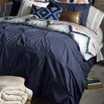 Rustic Small Bedroom with Bedding with Dark Blue Duvet and Tribal Patterned Pillow Case