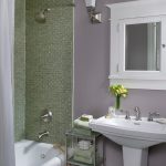 Tiny Bathroom Furnished by Modern Single Sink and Bathtub in White and Framed Mirror