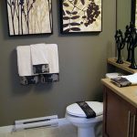 Tiny Bathroom in Dark Color Decorated with Contemporary Arts on the Wall and Modern Scluptures