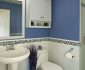 Tiny Bathroom with Beacy Theme Designed in White and Blue Colors with Blue Vase