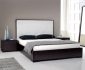 super sleek bedroom with white high headboard completed by modern night stand and navy blue pillows