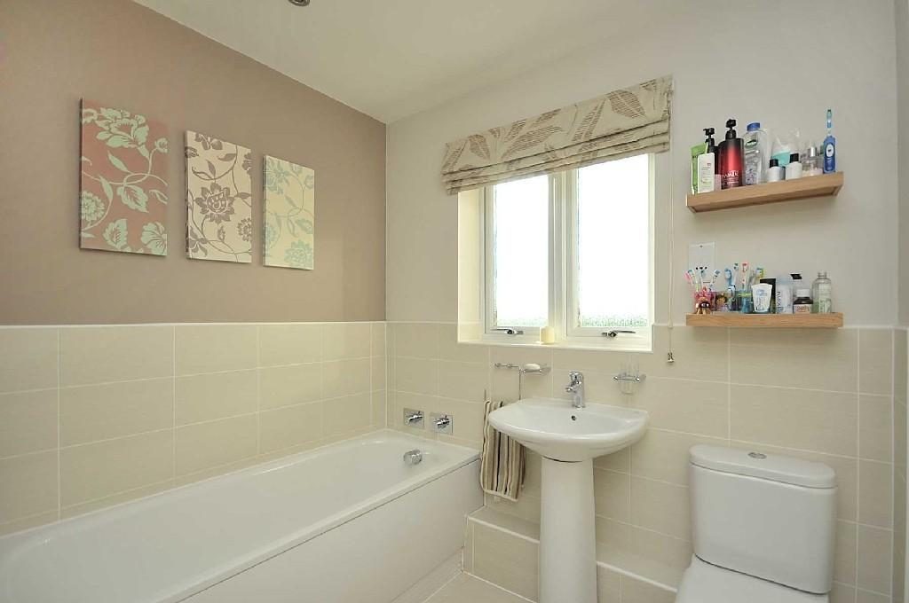 (7) Flower Wall Arts on Grey Wall inside Tiny Family Bathroom Ideas with Pedestal Sink and Long Bathtub